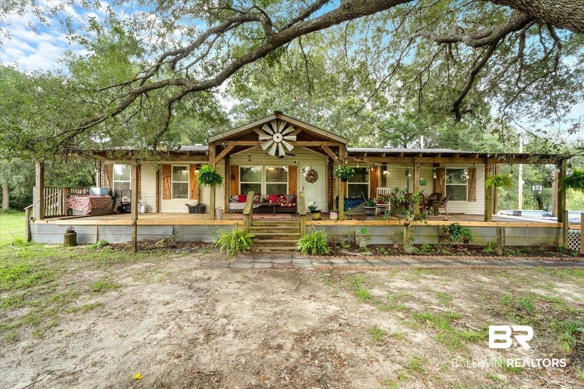 21011 River Road Robertsdale, AL 36567 - Photo 1 of 29 Ranch-style residence featuring a long, covered front porch with multiple seating areas