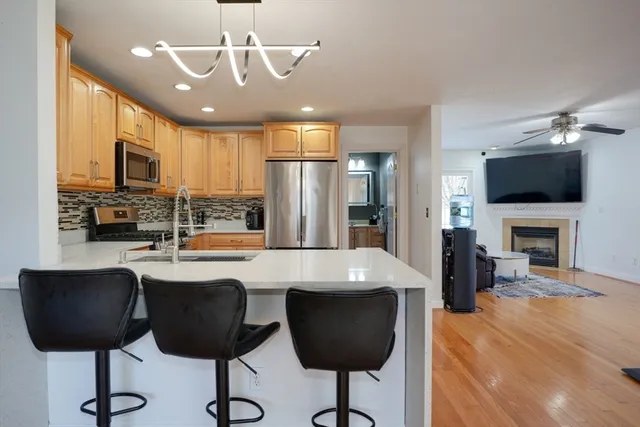 a large kitchen with a table and chairs