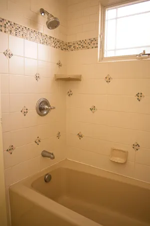 a spacious bedroom with a bed and wooden floor