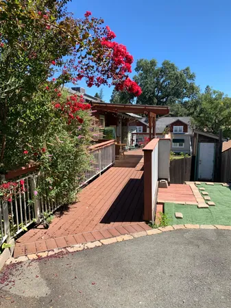 a view of a house with a yard and garden