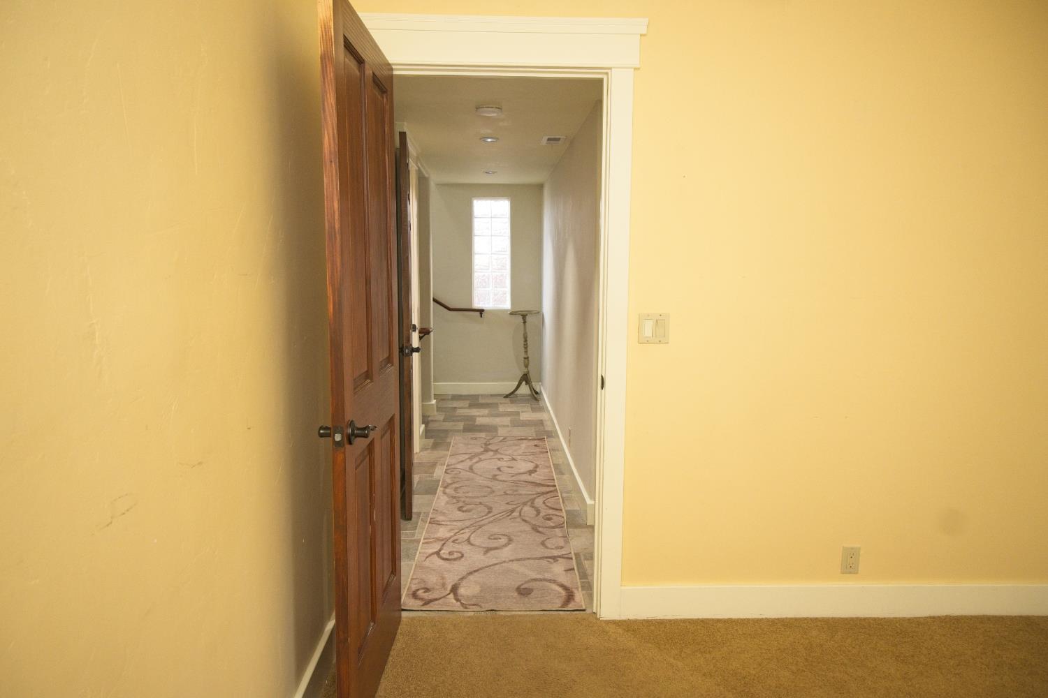 126 Center Street Jackson, CA 95642 - Photo 60 of 95 Custom tiled hallway off 3rd bedroom that has adjacent primary bedroom access and hall bath