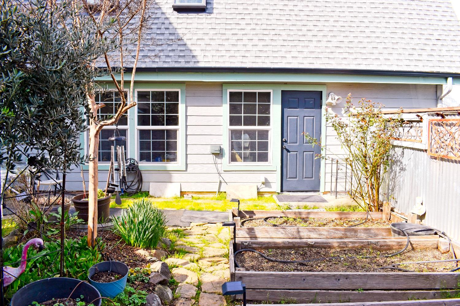 126 Center Street Jackson, CA 95642 - Photo 76 of 95 Lower level garden beds, cobbled courtyard and landscaping, facing garage which has access door