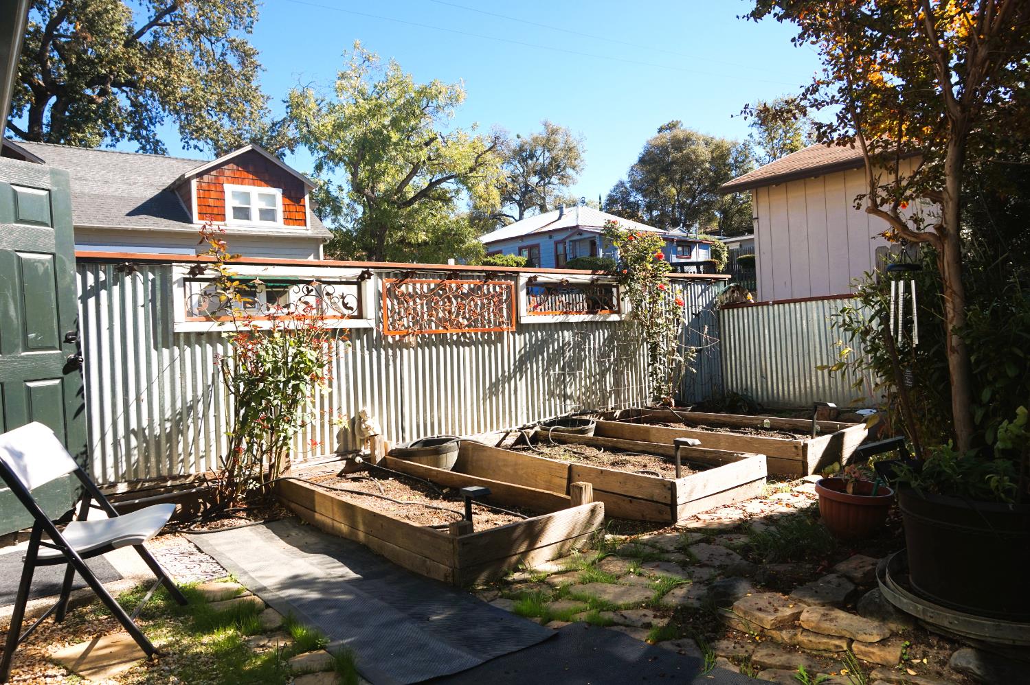 126 Center Street Jackson, CA 95642 - Photo 94 of 95 Lower garden beds facing East Ln with custom metal fencing, cobbled courtyard and pathways