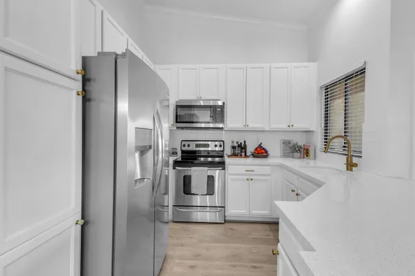 a kitchen with cabinets and stainless steel appliances