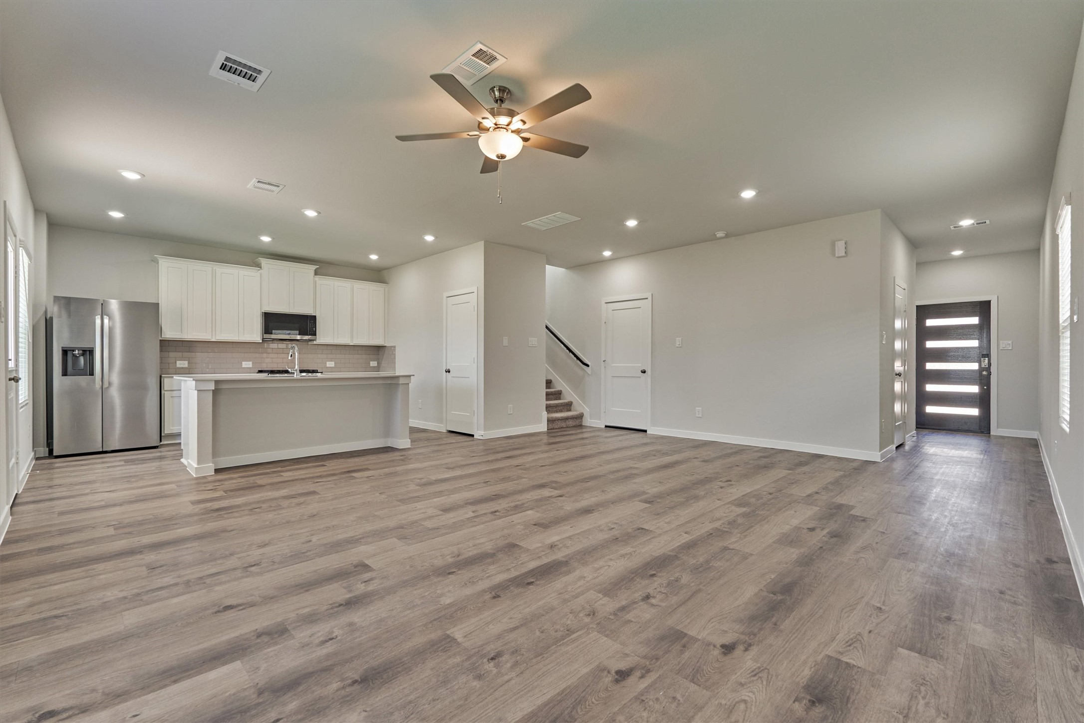 294 Brazen Forest Trail Magnolia, TX 77354 - Photo 11 of 37 a view of a kitchen with a stove cabinets and wooden floor