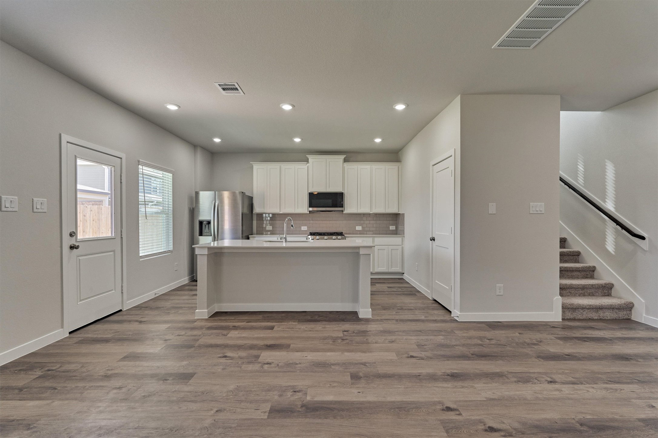294 Brazen Forest Trail Magnolia, TX 77354 - Photo 12 of 37 a view of kitchen with granite countertop refrigerator oven a sink and white cabinets with wooden floor