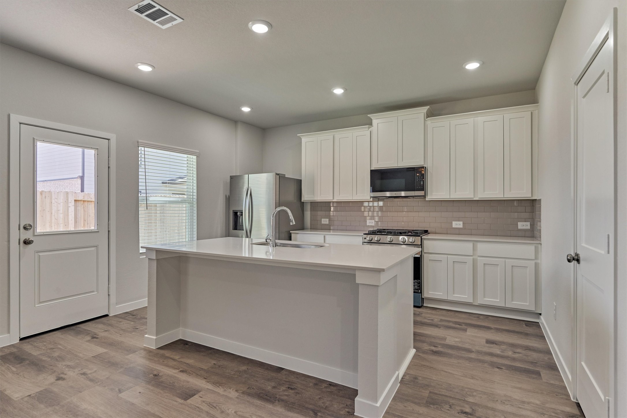 294 Brazen Forest Trail Magnolia, TX 77354 - Photo 13 of 37 a kitchen with stainless steel appliances granite countertop a stove a sink and a refrigerator