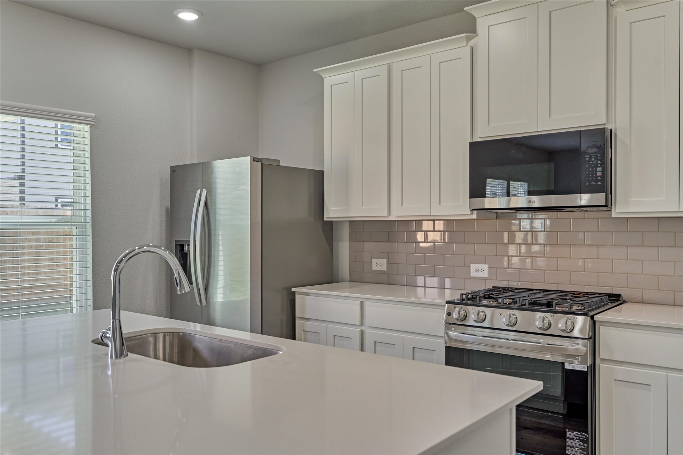 294 Brazen Forest Trail Magnolia, TX 77354 - Photo 15 of 37 a kitchen with stainless steel appliances granite countertop a sink stove and refrigerator