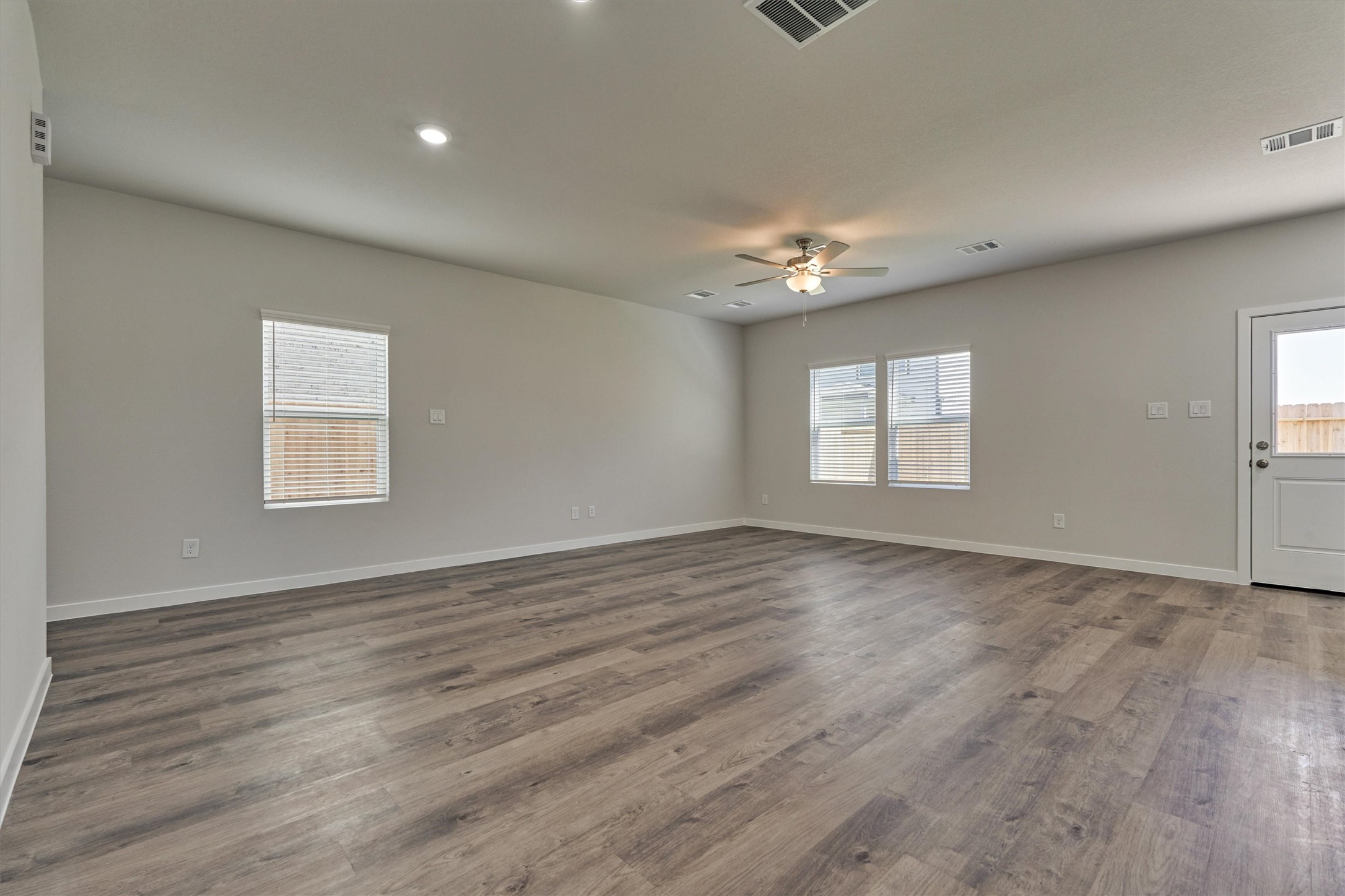294 Brazen Forest Trail Magnolia, TX 77354 - Photo 9 of 37 an empty room with wooden floor and windows