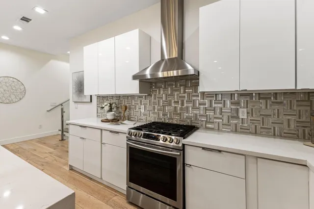a kitchen with a sink stove and cabinets