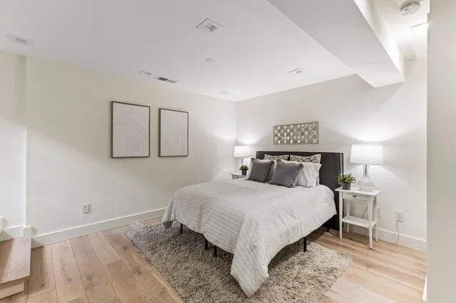 a bedroom with a bed and a night stand