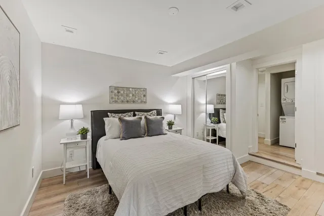 a bedroom with a bed and a night stand