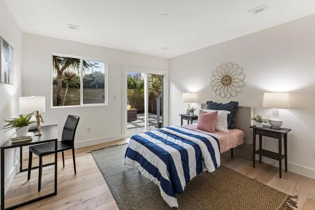 a bedroom with a bed a table and chair