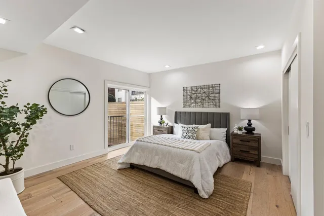 a bedroom with a bed and a mirror