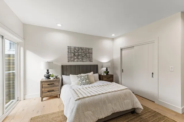 a bedroom with a bed and a painting