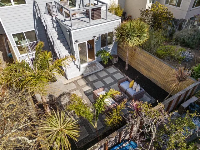 a backyard of a house with outdoor seating