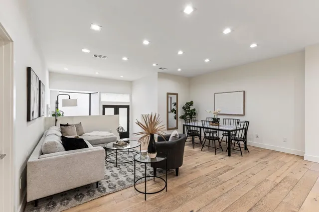 a living room with furniture wooden floor and a window