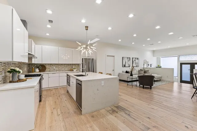 a kitchen with a sink cabinets and wooden floor