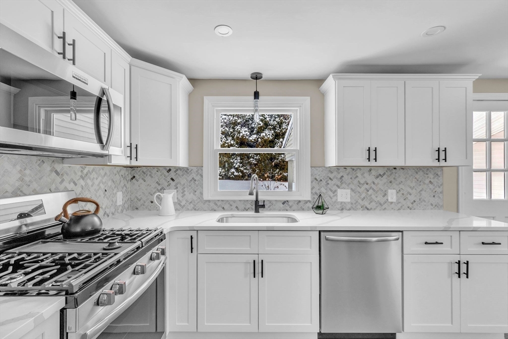 9 Edwill Road East Longmeadow, MA 01028 - Photo 4 of 34 a kitchen with granite countertop a sink stove and cabinets