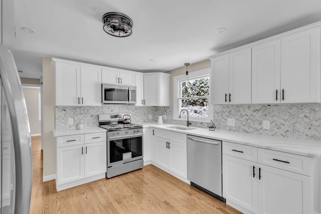 9 Edwill Road East Longmeadow, MA 01028 - Photo 5 of 34 a kitchen with white cabinets stainless steel appliances and sink