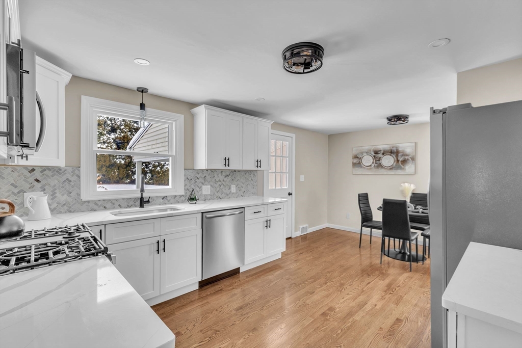 9 Edwill Road East Longmeadow, MA 01028 - Photo 6 of 34 a kitchen with stainless steel appliances granite countertop a refrigerator a sink a stove and white cabinets