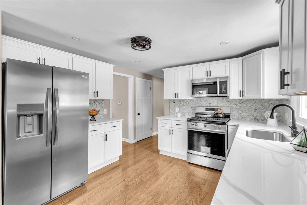 9 Edwill Road East Longmeadow, MA 01028 - Photo 7 of 34 a kitchen with stainless steel appliances cabinets a sink and a refrigerator