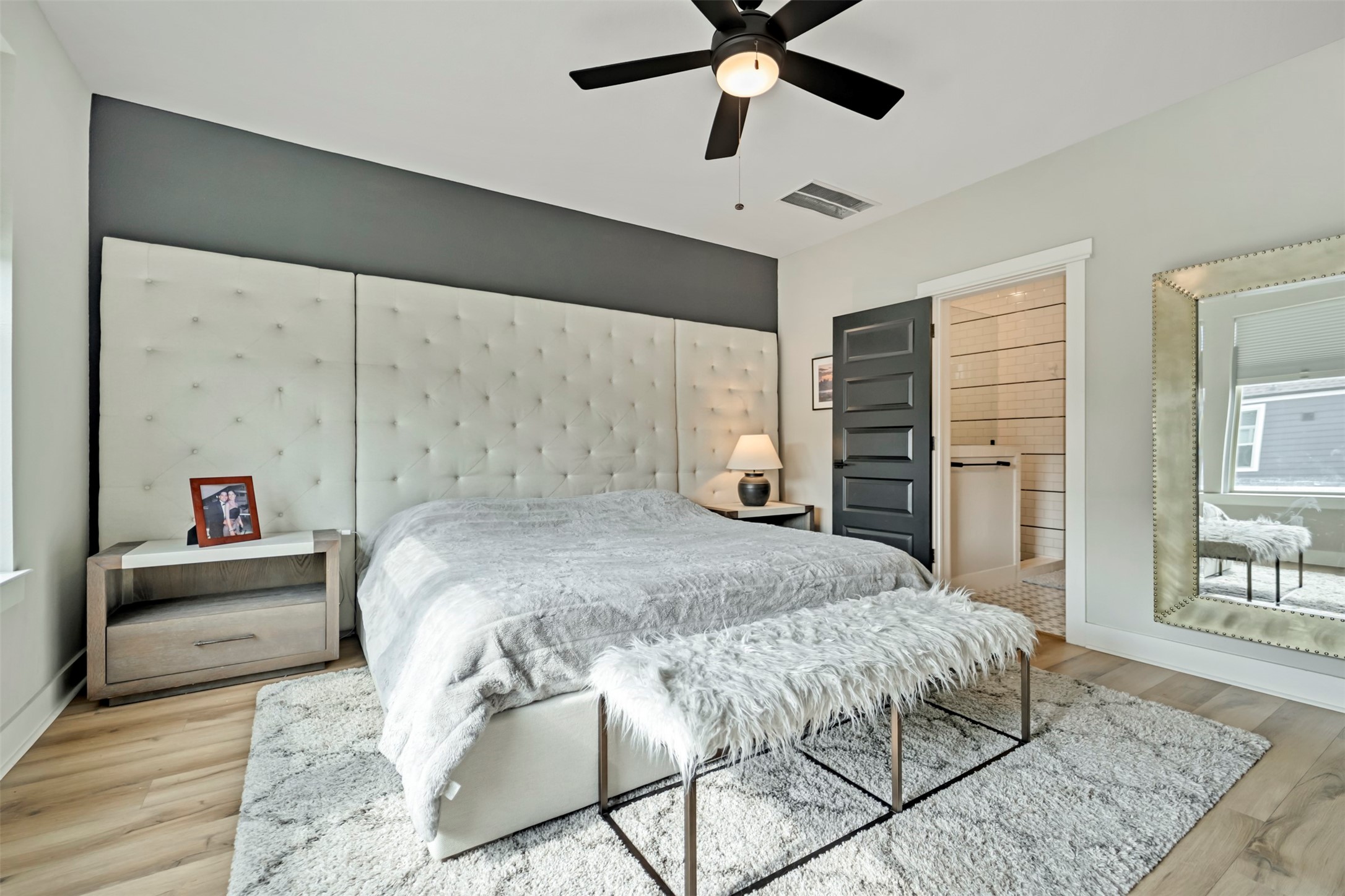 5209 Carters Bank Avenue Houston, TX 77091 - Photo 15 of 24 a bedroom with a large bed and a chandelier
