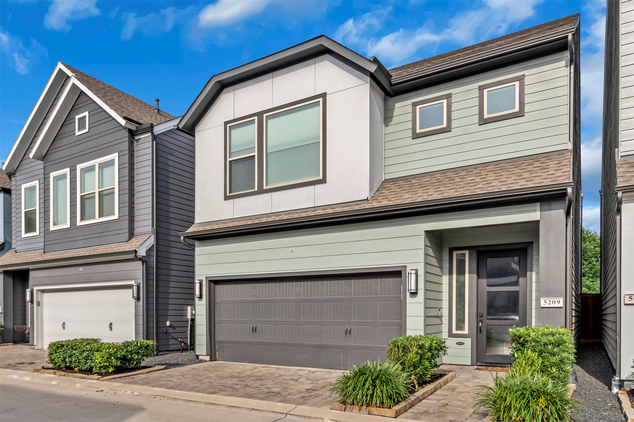 5209 Carters Bank Avenue Houston, TX 77091 - Photo 3 of 24 a front view of a house with a yard and garage