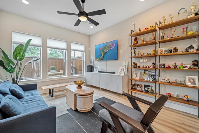 a living room with furniture a rug and a large window