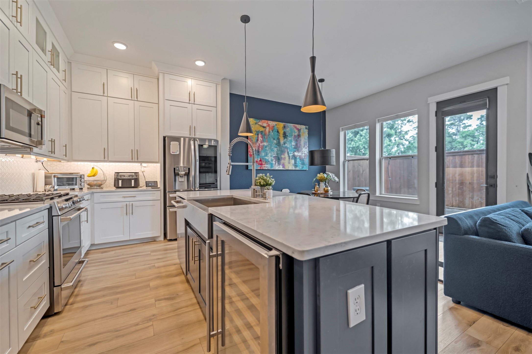 5209 Carters Bank Avenue Houston, TX 77091 - Photo 9 of 24 a kitchen with stainless steel appliances granite countertop a sink a stove a refrigerator cabinets and a chandelier