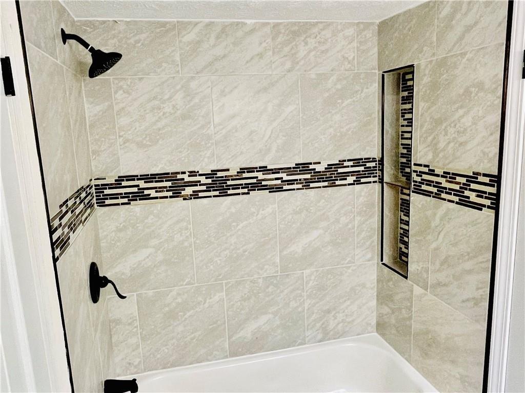 6434 Woodstone Way Morrow, GA 30260 - Photo 11 of 14 a bathroom with a shower