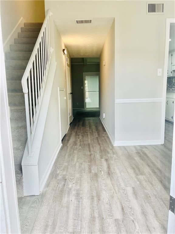 6434 Woodstone Way Morrow, GA 30260 - Photo 2 of 14 a view of a hallway with wooden floor and staircase