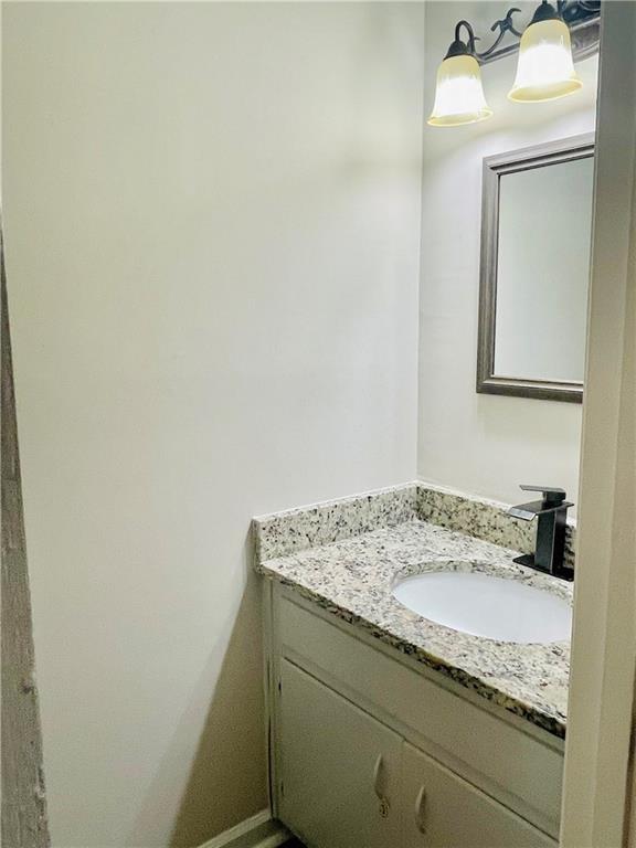 6434 Woodstone Way Morrow, GA 30260 - Photo 9 of 14 a bathroom with a granite countertop sink and vanity