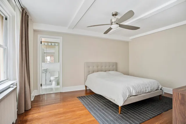 a bedroom with a large bed and a window