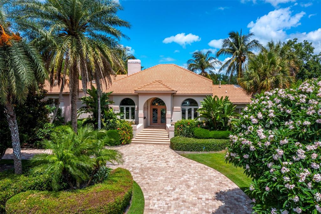 501 Harbor Gate Way Longboat Key, FL 34228 - Photo 1 of 1 a front view of a house with a garden