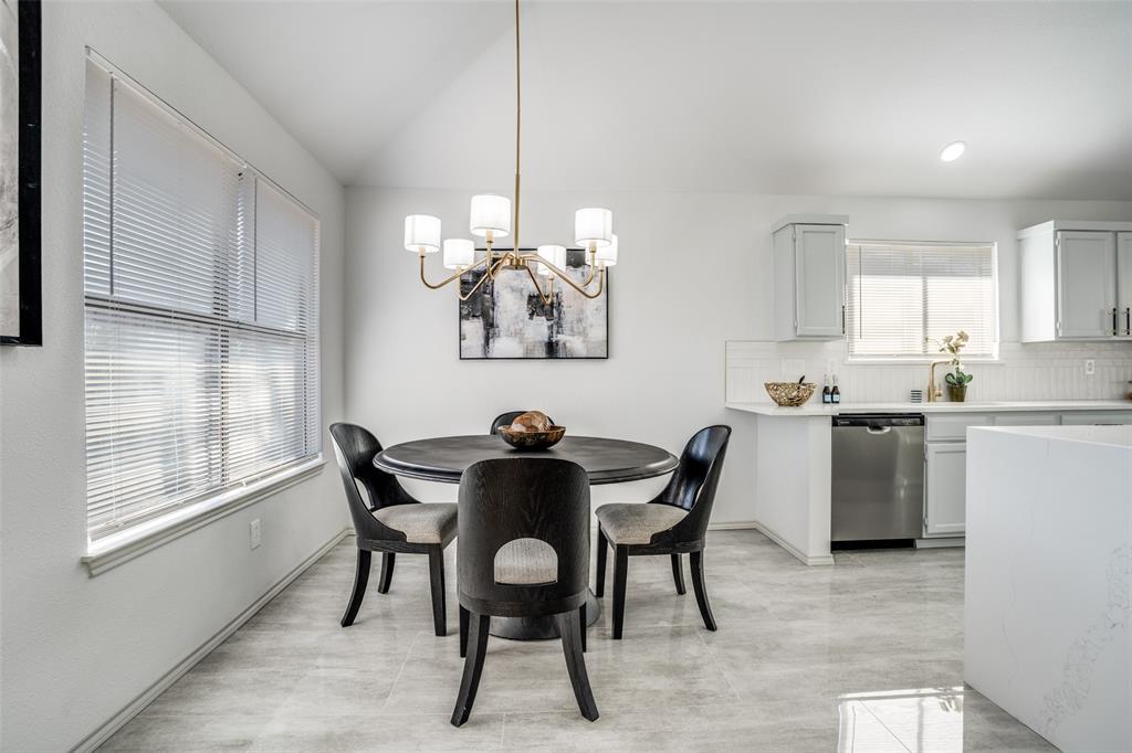 509 Rose Drive Allen, TX 75002 - Photo 13 of 25 a view of a dining room with furniture and chandelier