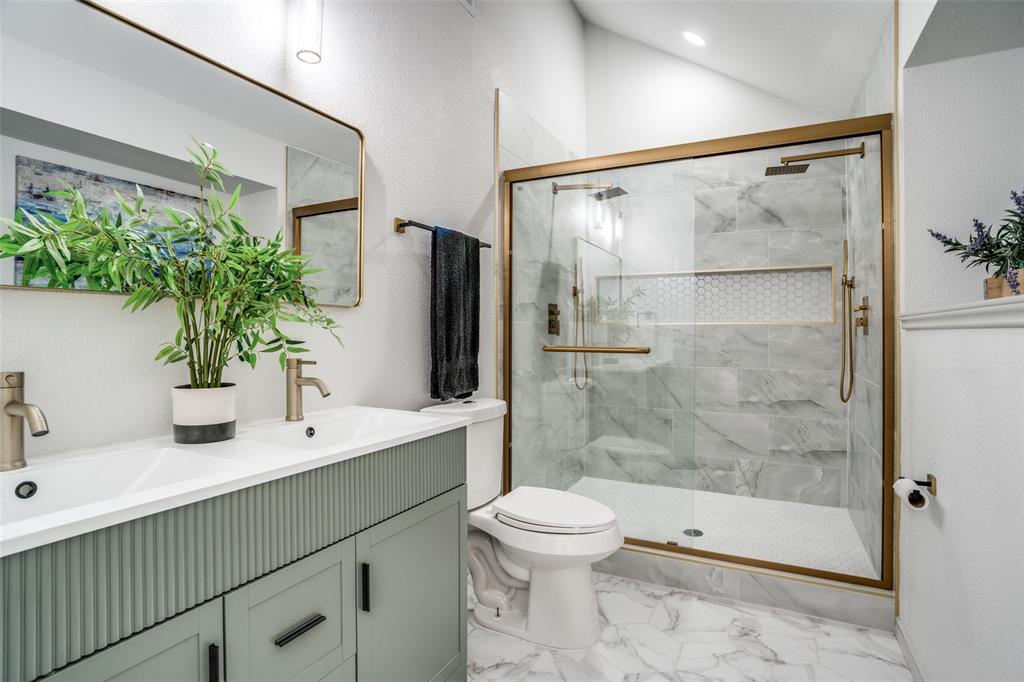 509 Rose Drive Allen, TX 75002 - Photo 18 of 25 a bathroom with a shower sink vanity mirror and toilet