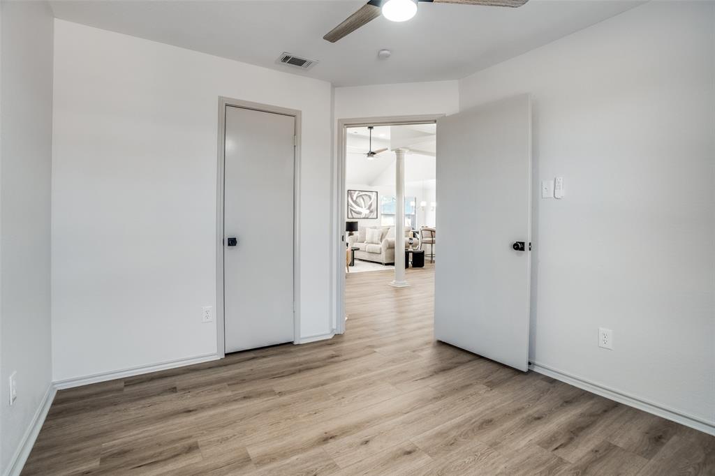 509 Rose Drive Allen, TX 75002 - Photo 19 of 25 a view of a hallway with wooden floor and a bathroom