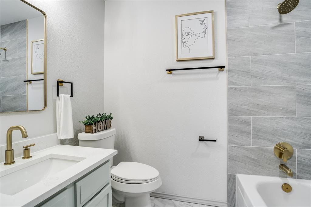 509 Rose Drive Allen, TX 75002 - Photo 21 of 25 a bathroom with a sink and mirror with toilet