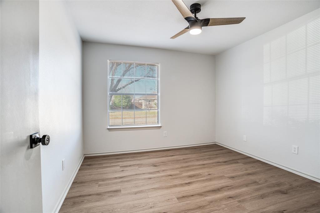 509 Rose Drive Allen, TX 75002 - Photo 22 of 25 an empty room with a window and a ceiling fan