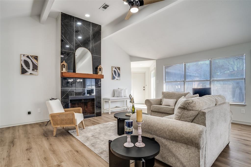509 Rose Drive Allen, TX 75002 - Photo 3 of 25 a living room with furniture and a fireplace