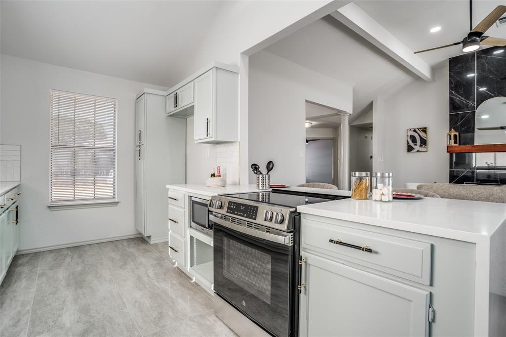 509 Rose Drive Allen, TX 75002 - Photo 10 of 25 a kitchen with a stove and a sink