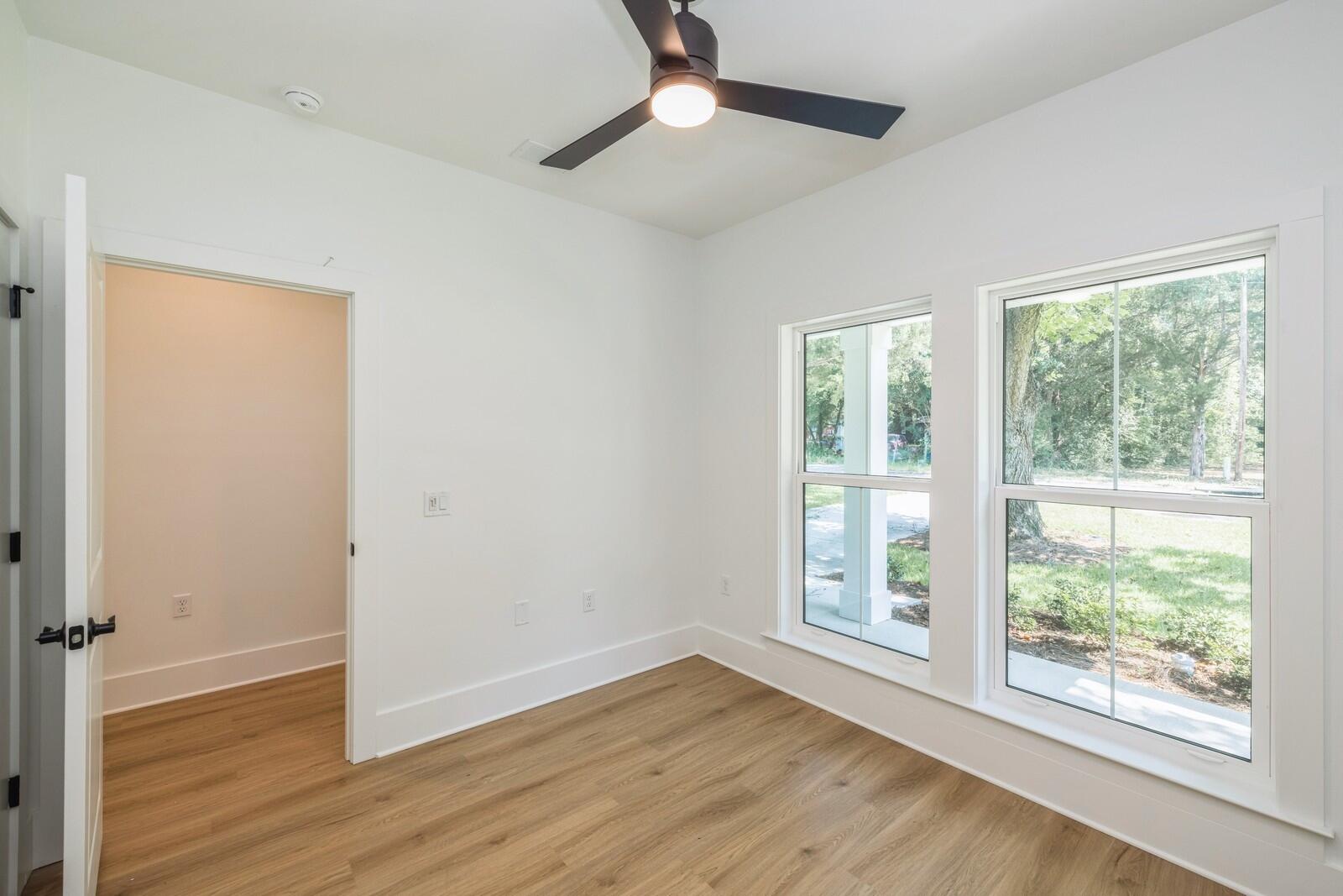 521 Brock Avenue Crestview, FL 32539 - Photo 11 of 16 a view of an empty room with wooden floor and a window