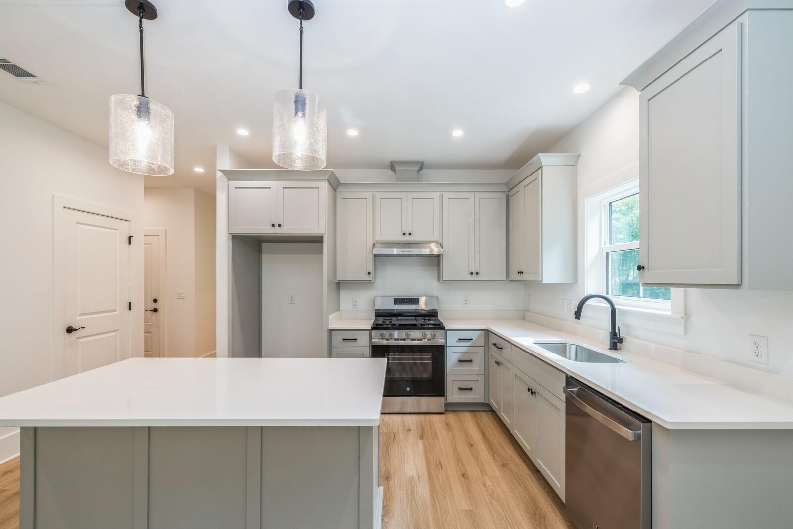 521 Brock Avenue Crestview, FL 32539 - Photo 4 of 16 a kitchen with stainless steel appliances granite countertop a sink a stove and a refrigerator