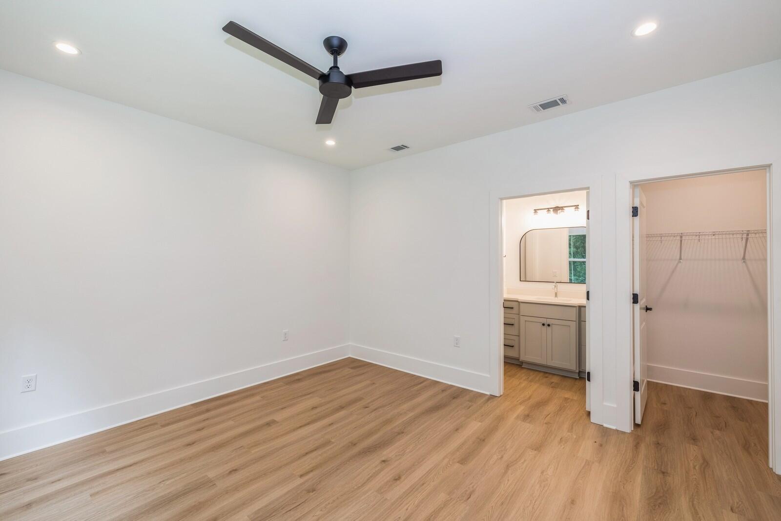 521 Brock Avenue Crestview, FL 32539 - Photo 9 of 16 a view of a room with wooden floor and a ceiling fan