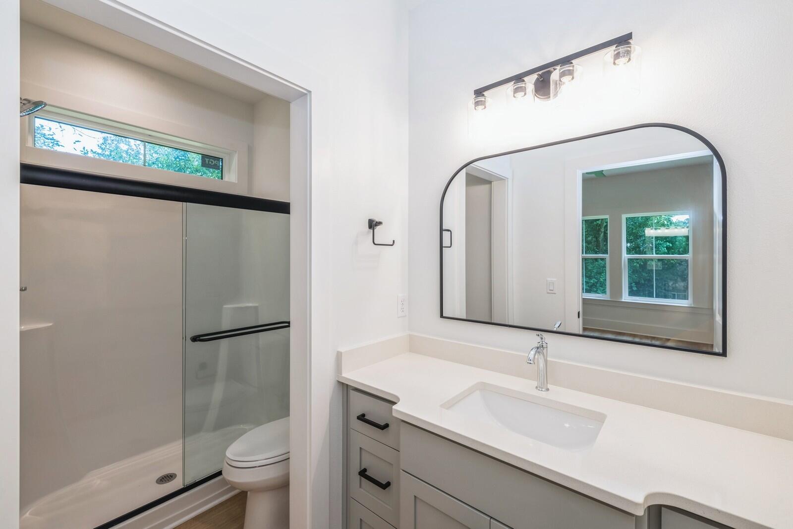 521 Brock Avenue Crestview, FL 32539 - Photo 10 of 16 a bathroom with a granite countertop sink mirror vanity and toilet