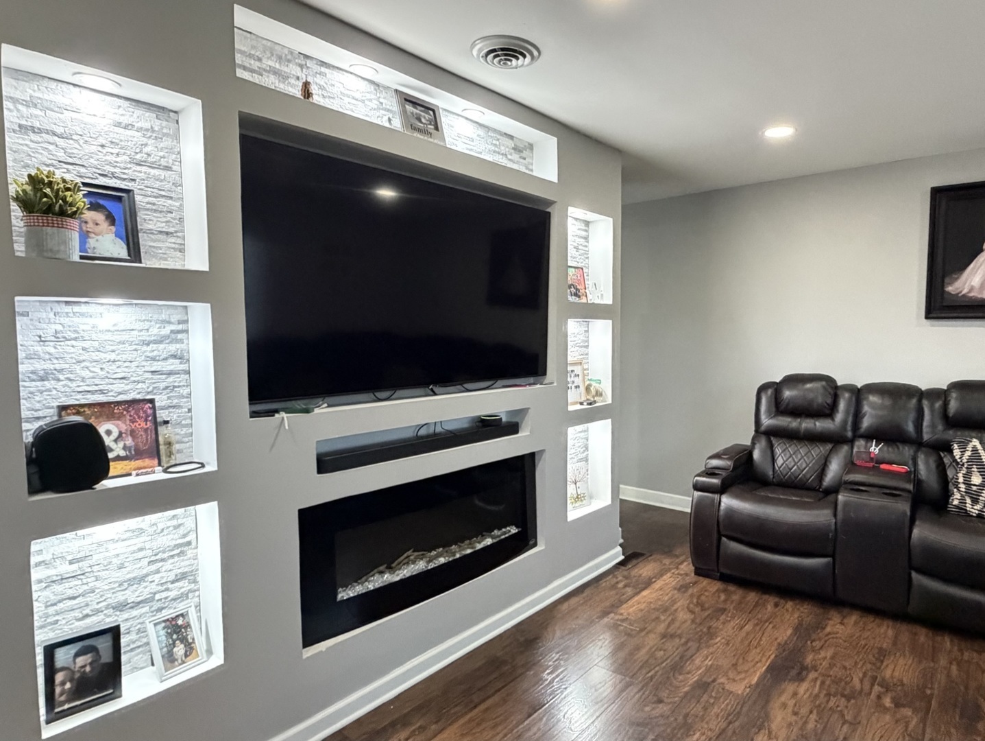 709 Hudson Avenue Romeoville, IL 60446 - Photo 12 of 16 a living room with furniture a flat screen tv and a fireplace