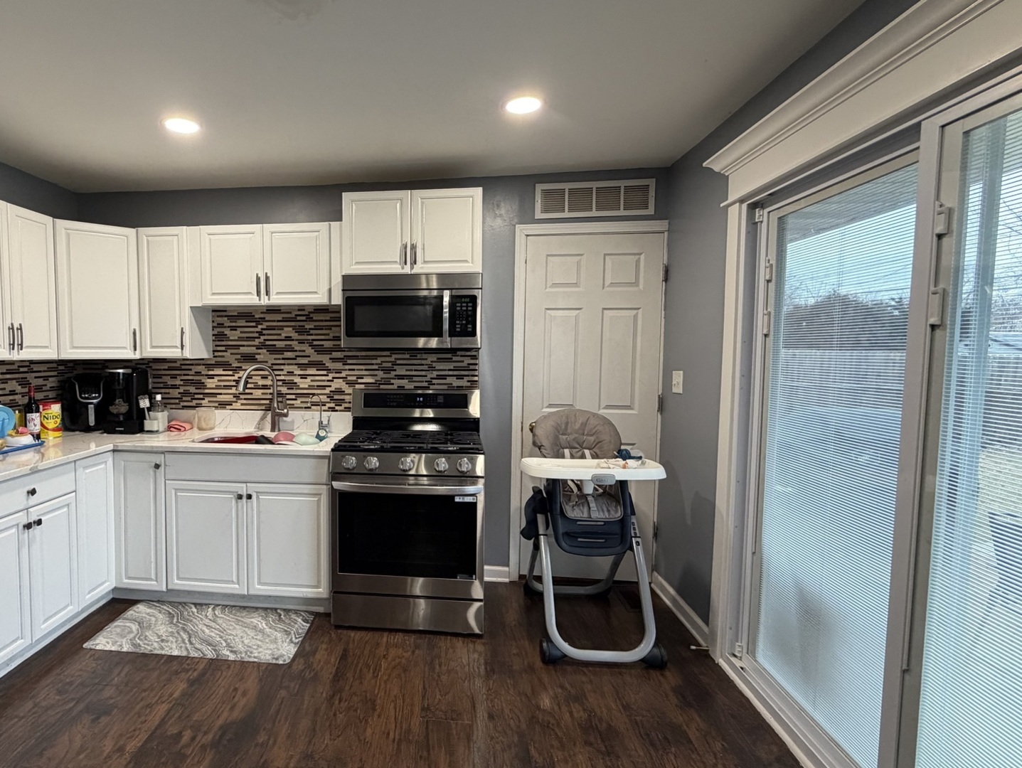 709 Hudson Avenue Romeoville, IL 60446 - Photo 8 of 16 a kitchen with stainless steel appliances a stove a sink and a refrigerator