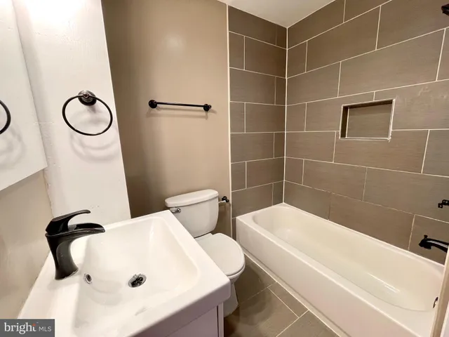 a bathroom with a bathtub and toilet