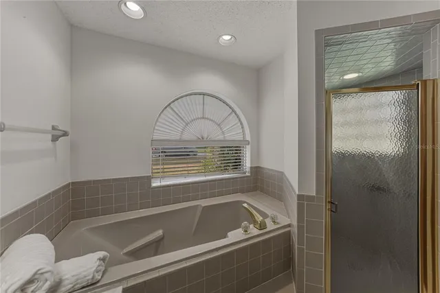 an empty room with wooden floor a fireplace and a window